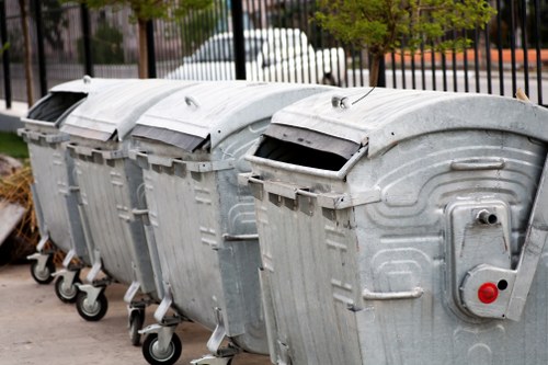 Professional waste clearance team sorting construction debris