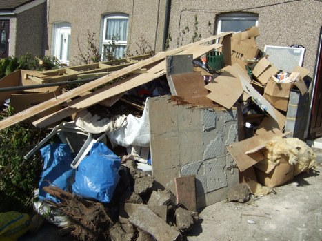 Collection of garden waste ready for removal in a Swiss Cottage garden
